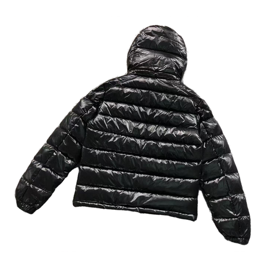 Black puffer jacket on a white background