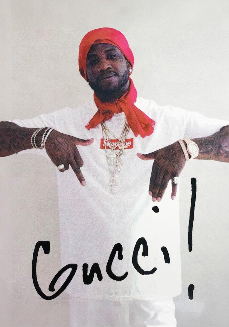 Person wearing a white t-shirt with a red bandana and gold jewelry, with 'Conci!' text.